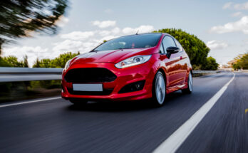 Red Mini Coupe Driving Highway With High Speed