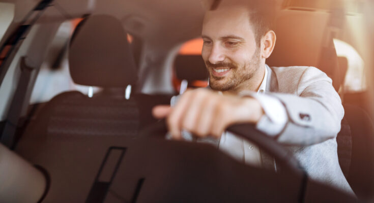 Handsome,businessman,driving,car,before,buying