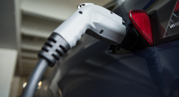 Close Up Car Being Charged With Electric Car Charger