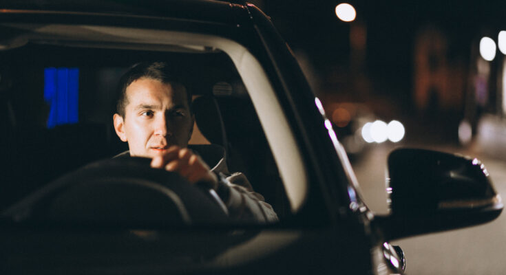 Young Man Driving His Car Night Time