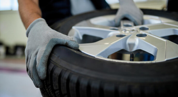 Closeup Mechanic Working With Car Tire Auto Repair Shop