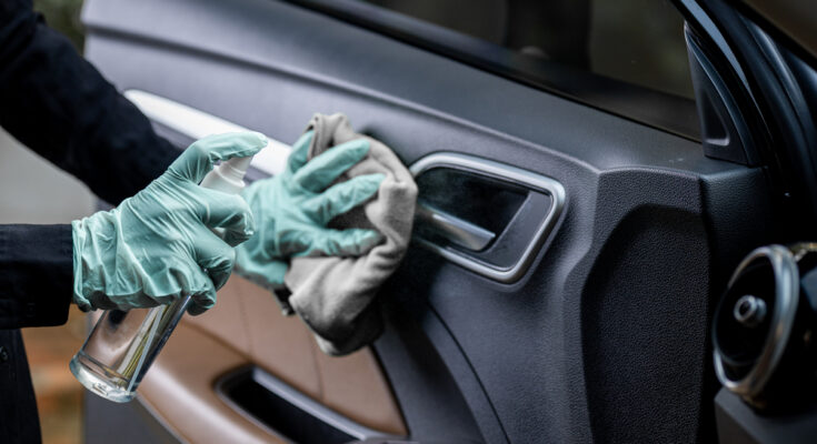 Car,disinfecting,service.,woman,disinfecting,and,cleaning,the,inside,handle