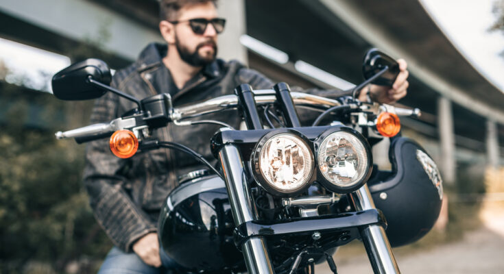 Portrait,of,a,handsome,male,biker,and,wearing,glasses.,close Up