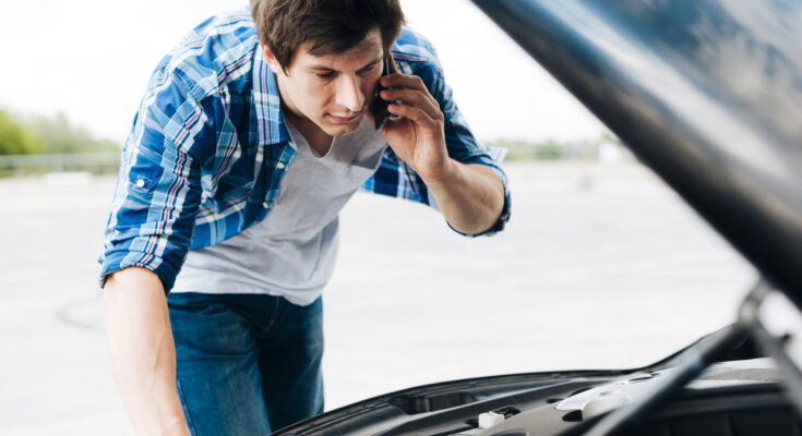 Man Checking Engine Talking Phone