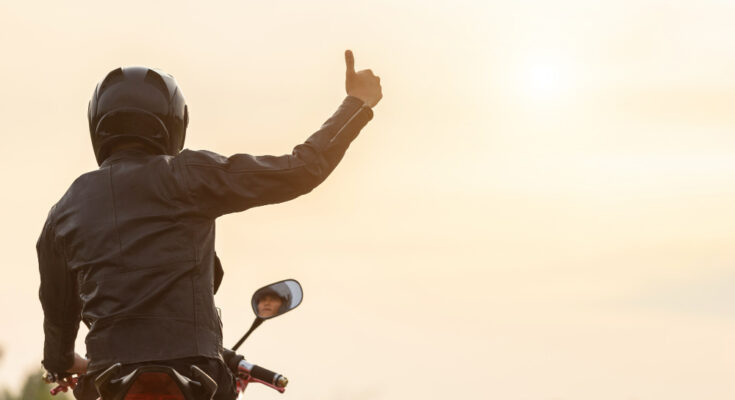 Handsome Motorcyclist Wear Leather Jacket Holding Helmet Road