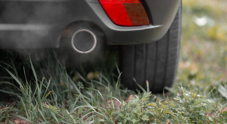 Toxic Co2 Exhaust Fumes From Exhaust Pipe Car Parked Lawn